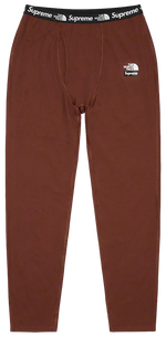 Brown pants with Supreme and The North Face logos on a white background