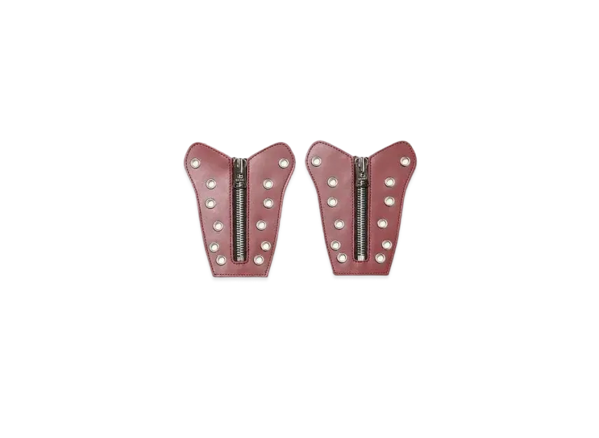 Two pink leather patches with zipper and studs on a white background