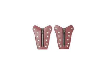 Two pink leather patches with zipper and studs on a white background